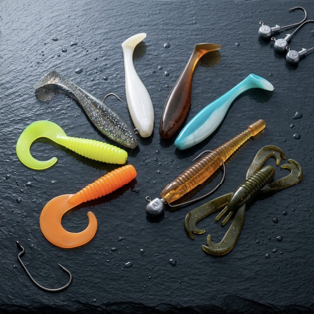 Paddle-tail shads, curly grubs and creature baits fanned across wet slate