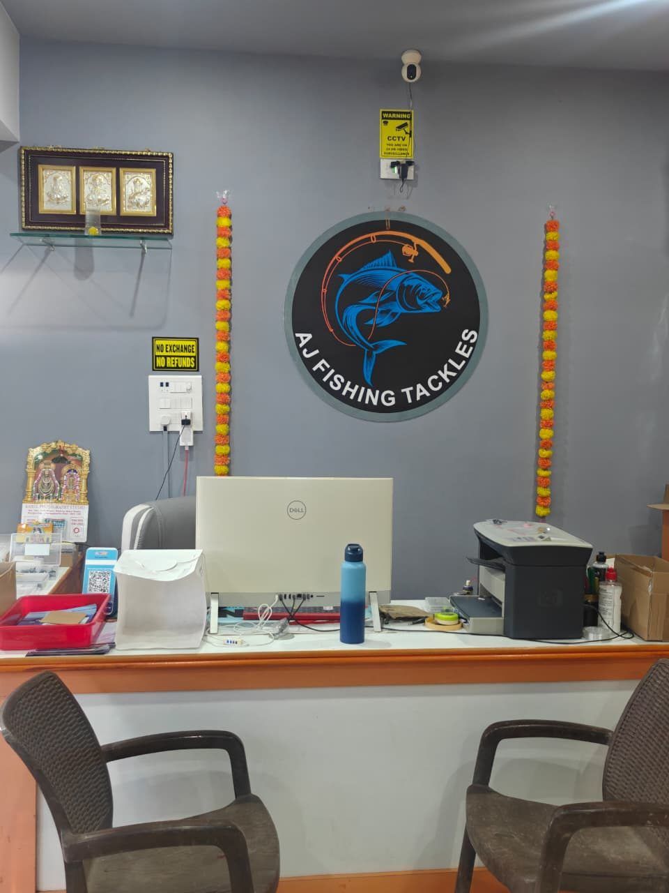 The AJ Fishing Tackles counter, with the shop sign on the wall behind